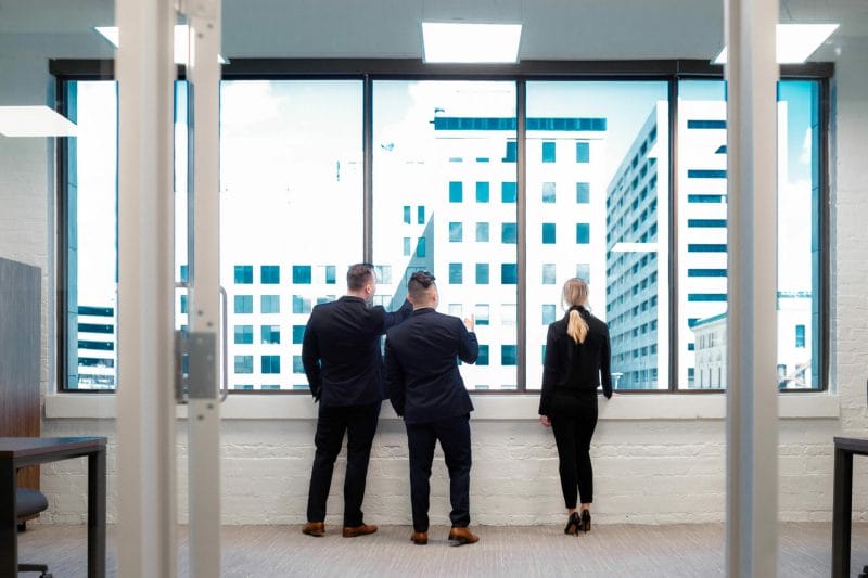A group of attorneys stare out at the Omaha skyline.