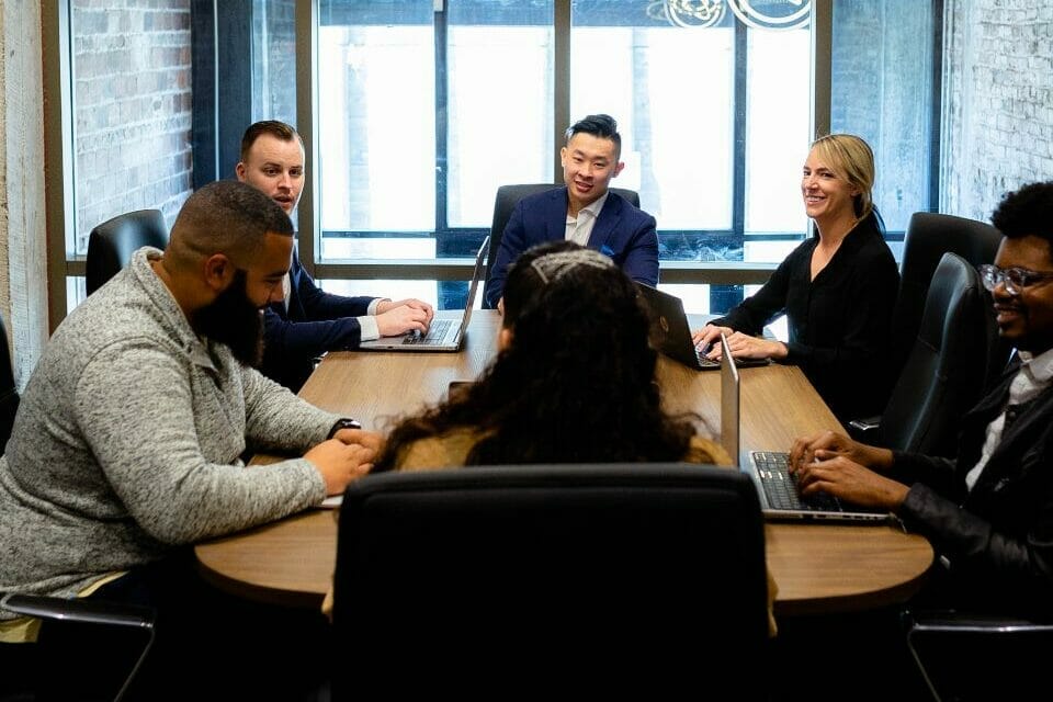 Group of professionals sitting in a conference room having a meeting.